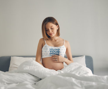 Sports Bra Mockup Featuring a Pregnant Woman Touching Her Belly