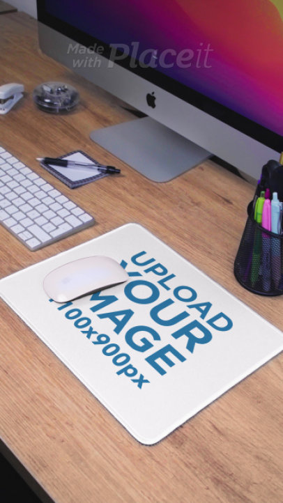 Video of a Mousepad Placed over a Wooden Desk Near an iMac 4934v