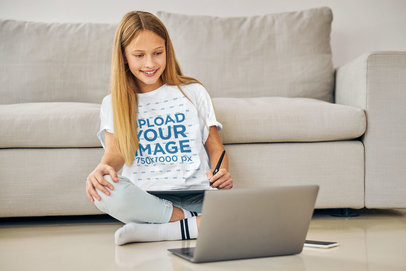 Round-Neck Tee Mockup of a Girl Taking Online Classes at Home