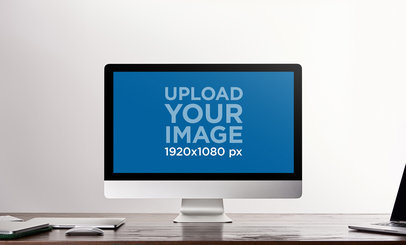 Mockup of an iMac Placed on a Desk with Other Devices