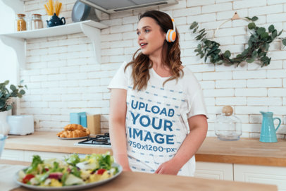 V-Neck Tee Mockup Featuring a Woman with Headphones in a Kitchen