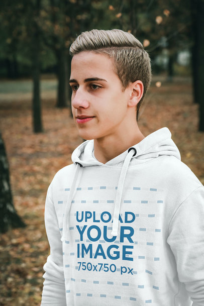 Hoodie Mockup Featuring a Young Man Posing at a Park During Fall m21433-r-el2