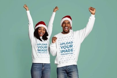 Mockup of a Happy Couple Wearing Round-Neck Sweatshirts and Santa Claus Hats