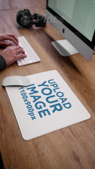 Mousepad Video Featuring a Wooden Desk and a Man Working On an iMac