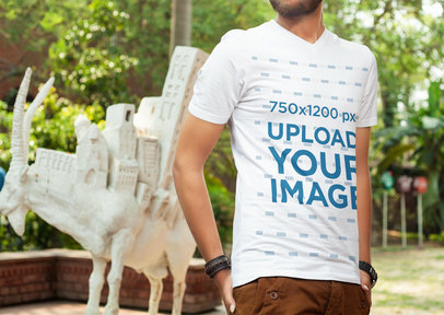 V-Neck T-Shirt Mockup of a Man Posing by a Goat Sculpture 5330 el1