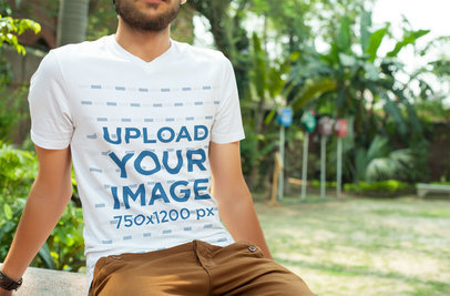 V-Neck Tee Mockup of a Bearded Man Sitting at a Garden 5331 el1