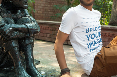 V-Neck Tee Mockup Featuring a Man Sitting Next to a Sculpture 5332 el1