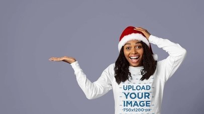 Sweatshirt Mockup Featuring a Smiling Woman With a Santa Hat