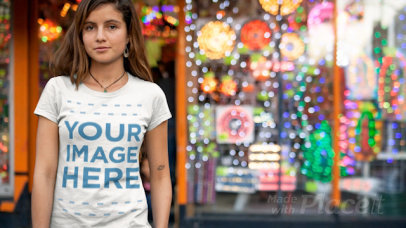 Young Woman Wearing a Round Neck T-Shirt Cinemagraph in Front of a Store With Flashing Lights