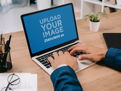 Mockup of an Executive Working on His MacBook