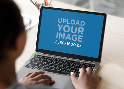 Mockup Featuring a Teenager Using a MacBook Pro m16385-r-el2