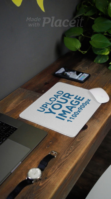  Video Featuring a Mousepad Placed on a Rustic Wooden Desk Near a Phone and a Laptop