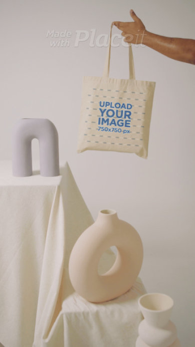 Video of a Man Holding a Tote Bag Featuring a Pottery Theme