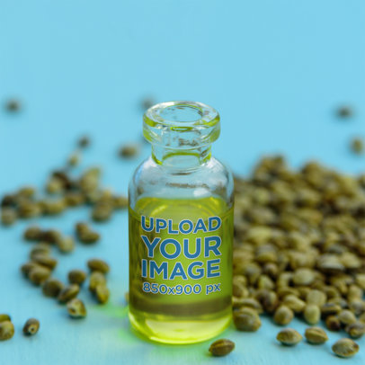 Mockup Featuring a Small Glass Bottle and Cannabis Seeds