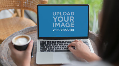 Mockup Featuring a Woman Working on a MacBook and Drinking Coffee