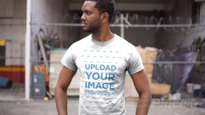 Handsome Black Man Wearing a Tshirt Video Standing Outside an Abandoned City Building a12119