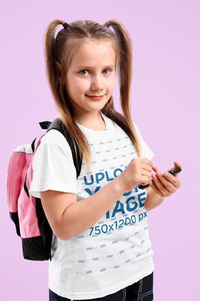 T-Shirt Mockup Featuring a Girl With a Cellphone on Her Hand