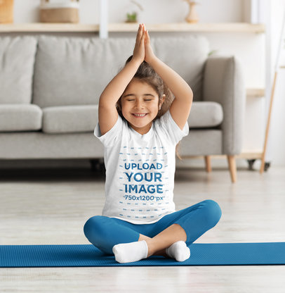 T-Shirt Mockup of a Smiling Girl Doing Yoga at Home