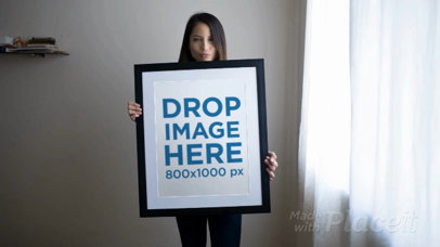 Beautiful Woman Holding a Big Framed Art Print Video While Doing Faces