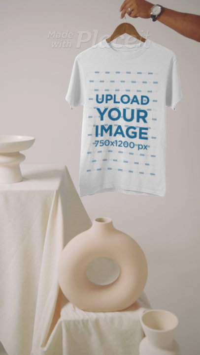 Video of a Person Holding a T-Shirt in a Pottery-Themed Set 5026v