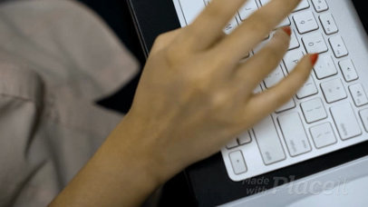 Girl Using Her iMac While a Business Card Video Lies on Her Desk a13920