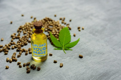 Mockup of a Glass Bottle Surrounded by Cannabis seeds and a Leaf