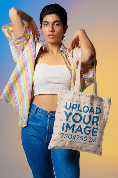 Mockup of a Tote Bag Featuring a Woman Standing Against a Colorful Background