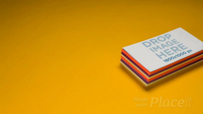 Pile of Business Cards Video Mockup Lying over a Yellow Background a13965