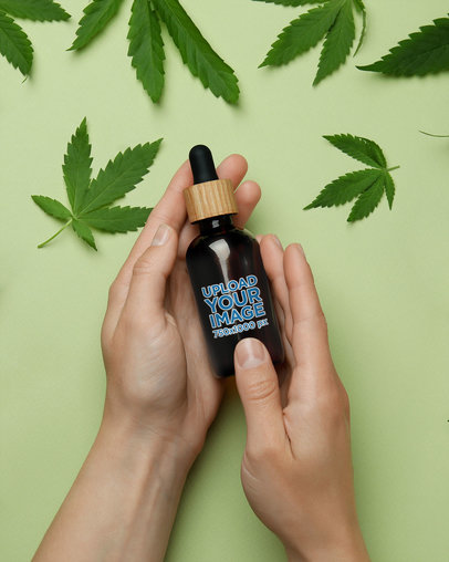 Mockup of a Person Holding a Dropper of CBD Oil Featuring Marijuana Leaves M23400-r-el2
