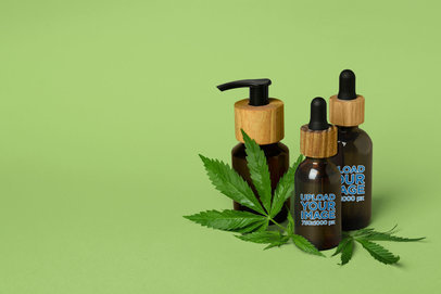 Mockup of Amber Dropper Bottles Placed by a Cannabis Leaf