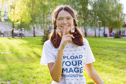 T-Shirt Mockup Featuring a Happy Teenager Making the Secret Sign with her Finger