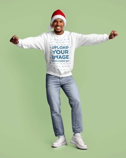 Sweatshirt Mockup Featuring a Smiling Man Wearing a Santa Claus Hat in a Studio