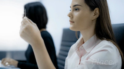 Office Woman Looking at a Business Card Video While at Work