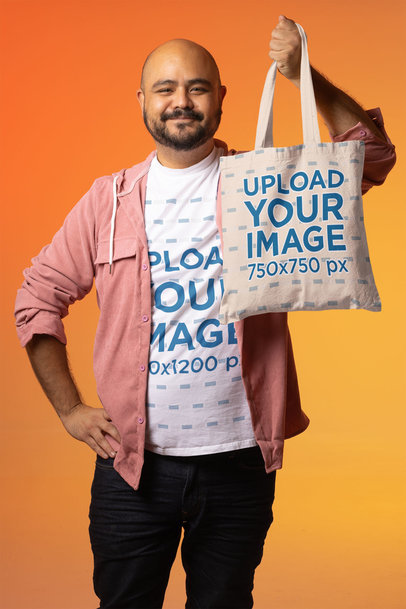 T-Shirt Mockup Featuring a Happy Man Showing His Tote Bag
