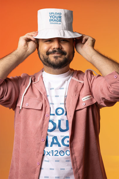 Mockup Featuring a Happy Man Wearing a Customizable T-Shirt and a Bucket Hat 