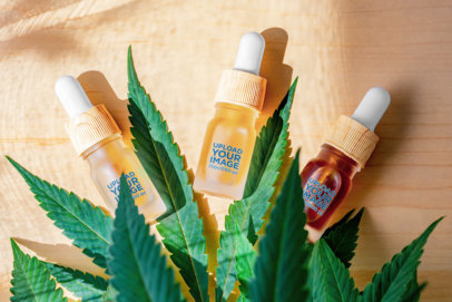 Mockup of Three Dropper Bottles Featuring a Cannabis Plant