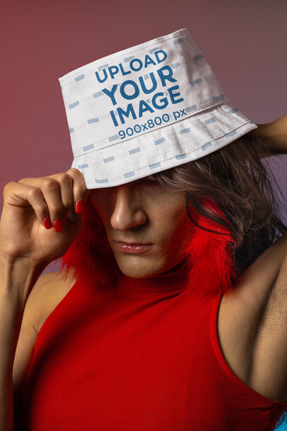 Mockup of a Sassy Trans Woman Wearing a Bucket Hat and Feather Earrings