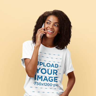 T-Shirt Mockup of a Happy Woman Talking on the Phone in a Studio
