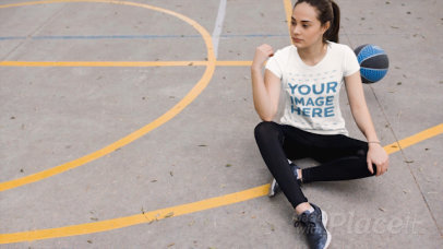 Woman Wearing a Round Neck Tshirt Cinemagraph Sitting Down Near a Bouncing Basketball