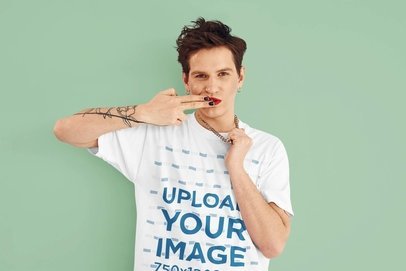 T-Shirt Mockup of a Tattooed Man Wearing Red Lipstick