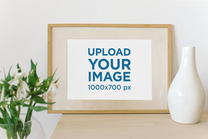 Mockup of a Horizontal Art Print on a Wooden Table