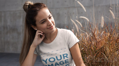 Woman with a Hair Bun Wearing a Round Neck Tee Stop Motion Video Outdoors