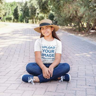 Heathered T-Shirt Mockup Featuring a Happy Girl Sitting on the Floor