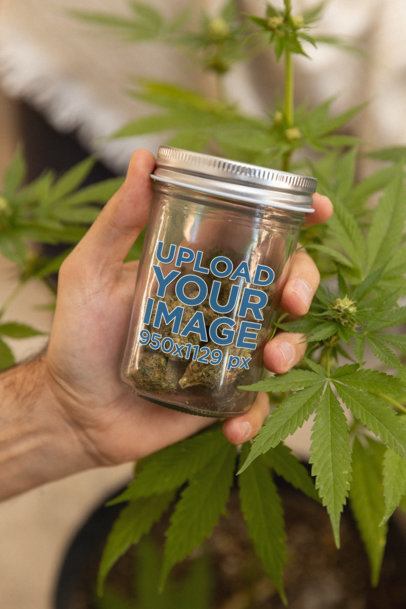 Mockup of the Hand of a Man Holding a Mason Jar with Cannabis M25447