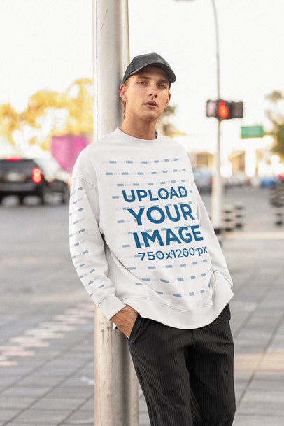 Sweatshirt Mockup Featuring a Man Posing at the City with a Serious Look