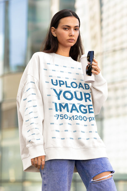 Mockup Featuring a Serious Woman Wearing an Oversized Sweatshirt With Customizable Sleeves