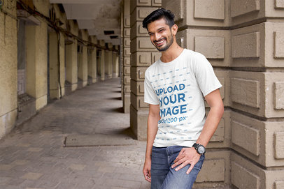 T-Shirt Mockup of a Happy Bearded Man Posing in a Hallway