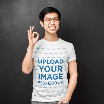 T-Shirt Mockup of a Man with Glasses Making an Approval Sign