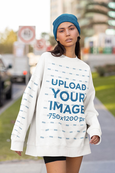 Oversized Sweatshirt with Sleeves Mockup Featuring a Woman Posing in the Street