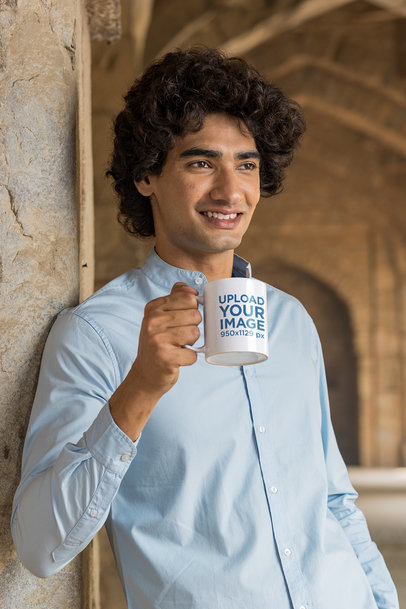 Mockup of a Happy Man Holding a Mug while Leaning on a Wall